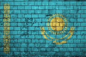 Kazakhstan flag is painted onto an old brick wall photo