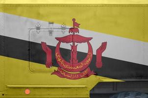 Brunei Darussalam flag depicted on side part of military armored truck closeup. Army forces conceptual background photo