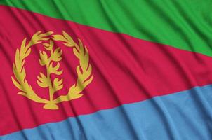 Eritrea flag is depicted on a sports cloth fabric with many folds. Sport team banner photo