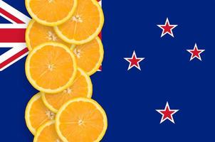 New Zealand flag and citrus fruit slices vertical row photo