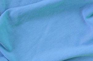 The texture of the fabric in blue color. Material for making shirts and blouses photo