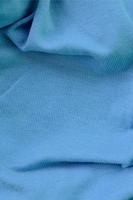 The texture of the fabric in blue color. Material for making shirts and blouses photo