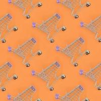 Shopping addiction, shopping lover or shopaholic concept. Many small empty shopping carts perform a pattern on a pastel colored paper background. Flat lay composition, top view photo