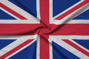 Great britain flag is depicted on a sports cloth fabric with many folds. Sport team banner photo