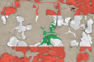 Lebanon flag depicted in paint colors on old obsolete messy concrete wall closeup. Textured banner on rough background photo