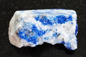 raw lapis lazuli stone on dark background photo