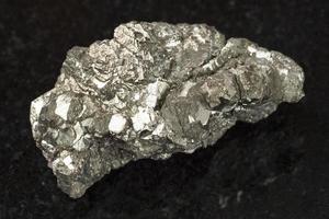 rough marcasite stone white iron pyrite on dark photo