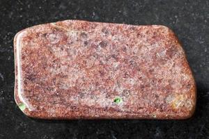 tumbled slab of aventurine gemstone on dark photo