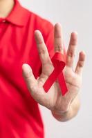 Red Ribbon for December World Aids Day, acquired immune deficiency syndrome, multiple myeloma Cancer Awareness month and National Red ribbon week. Healthcare and world cancer day concept photo