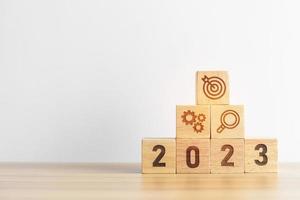 2023 wood block with business goal, plan. Action strategy, target, mission, teamwork, idea and New Year start concept photo