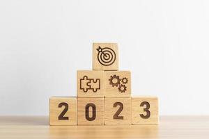 2023 wood block with business goal, plan. Action strategy, target, mission, teamwork, idea and New Year start concept photo