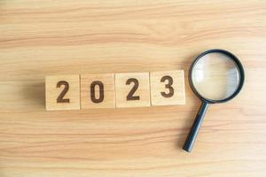 2023 block with magnifying glass. SEO, Search Engine Optimization, hiring , Advertising, Idea, Strategy, marketing, Keyword, Content and New Year start concepts photo