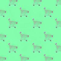 Shopping addiction, shopping lover or shopaholic concept. Many small empty shopping carts perform a pattern on a pastel colored paper background. Flat lay composition, top view photo