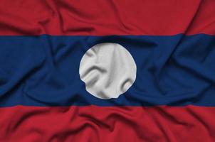 Laos flag is depicted on a sports cloth fabric with many folds. Sport team banner photo