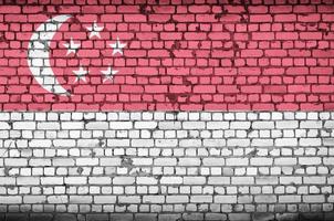 Singapore flag is painted onto an old brick wall photo