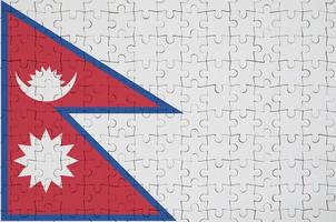 Nepal flag is depicted on a folded puzzle photo