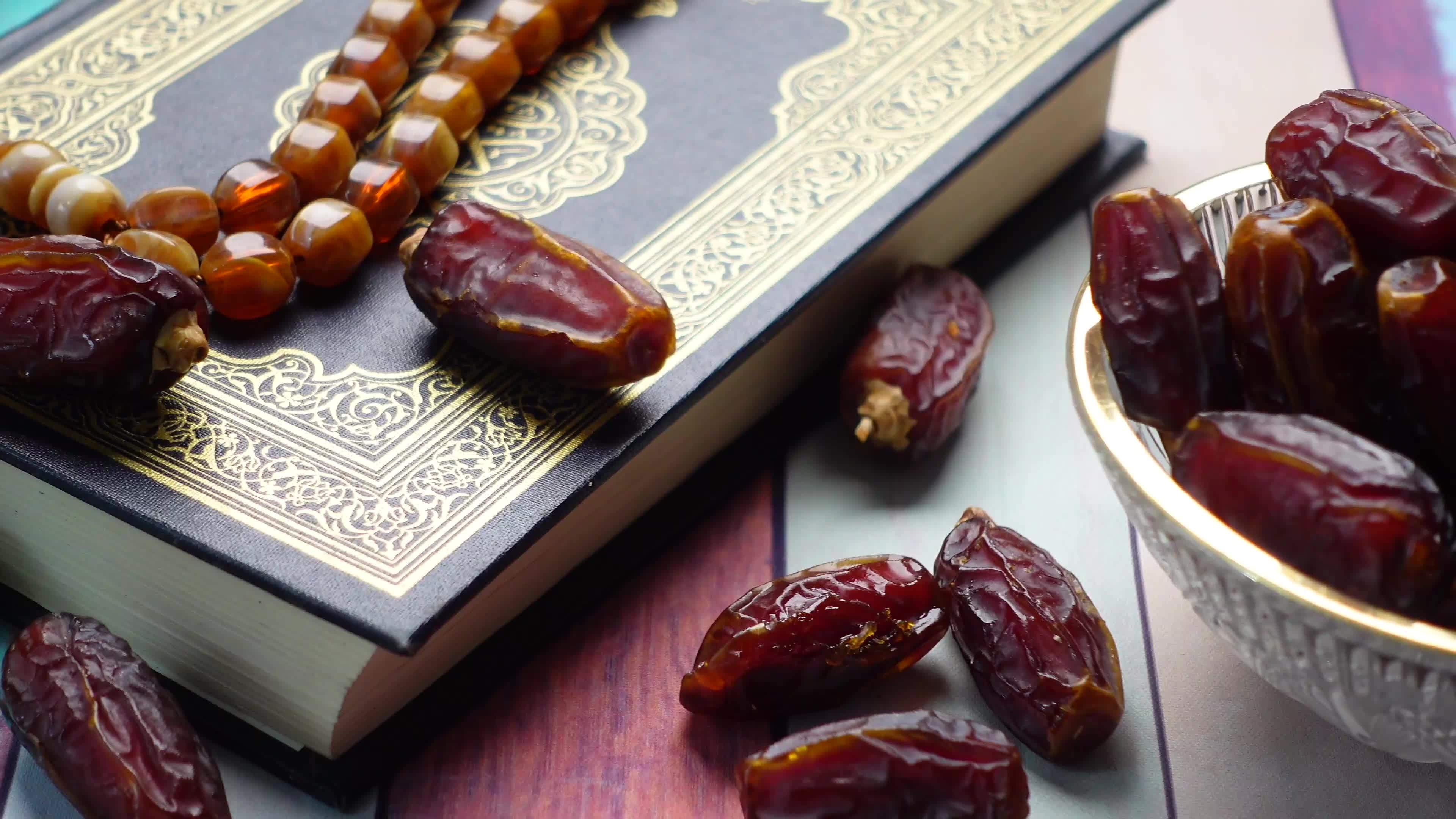 Dates and Islam prayer beads on Quran symbols of Ramadan 13996519 Stock