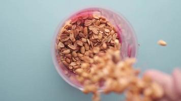 Overhead view of peanuts falling into a container in slow motion video