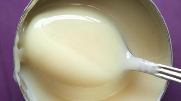 Spoon in condensed milk can video