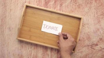 A wood tray and a Donate sign video