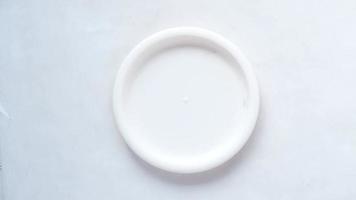 Piling up plates on white background video