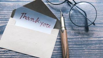 Thank you note with round framed glasses and an ink pen video