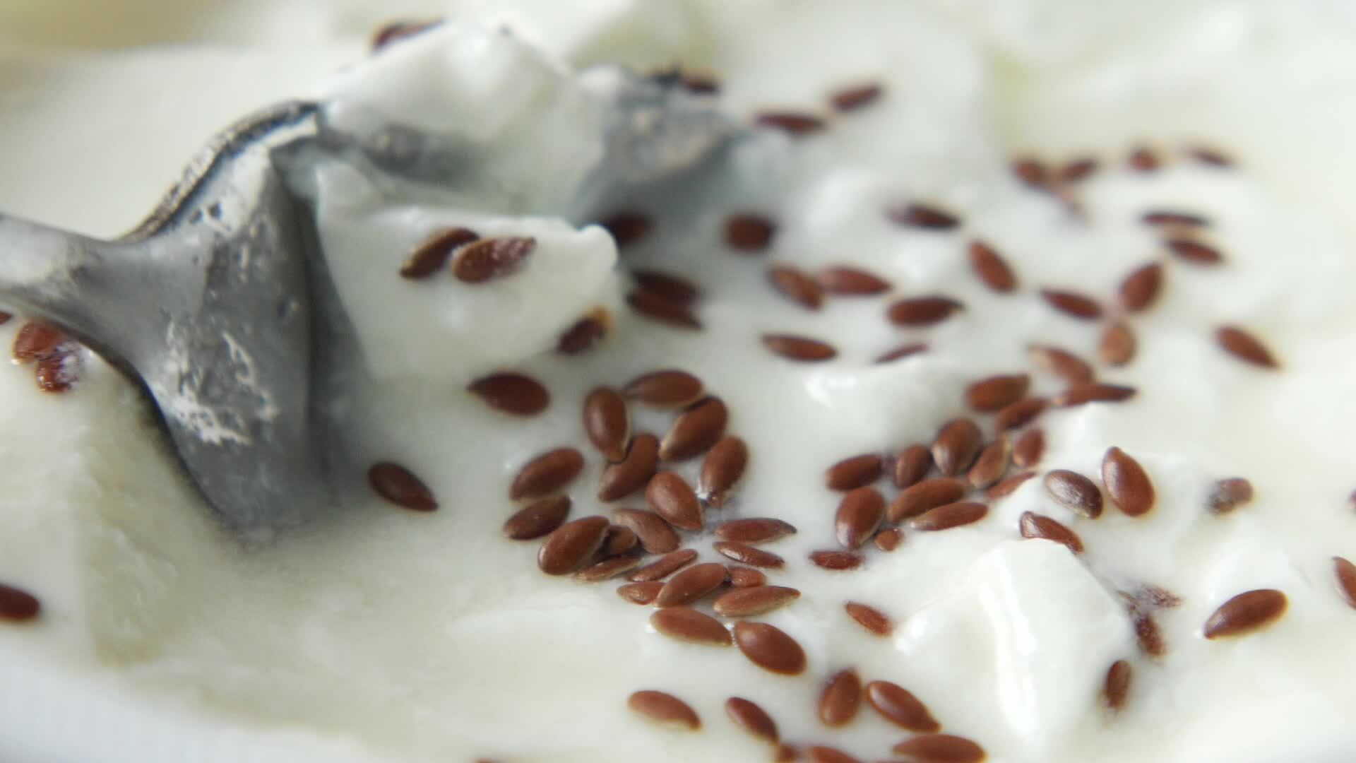 Flax seed on yogurt, close up 13996554 Stock Video at Vecteezy