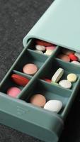 A pill box with many compartments and pills video