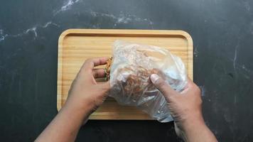 Taking a nut bread from plastic bag