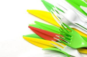 Pile of bright yellow, green and white plastic kitchenware single use appliances photo