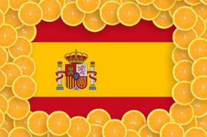 Spain flag in fresh citrus fruit slices frame photo
