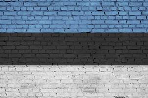 Estonia flag is painted onto an old brick wall photo