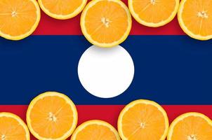 Laos flag in citrus fruit slices horizontal frame photo