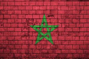 Morocco flag is painted onto an old brick wall photo