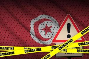 Tunisia flag and Covid-19 quarantine yellow tape. Coronavirus or 2019-nCov virus photo