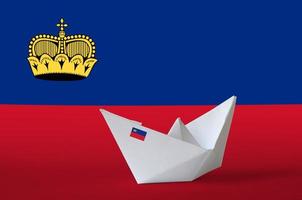 Liechtenstein flag depicted on paper origami ship closeup. Handmade arts concept photo