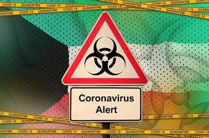 Kuwait flag and Covid-19 biohazard symbol with quarantine orange tape. Coronavirus or 2019-nCov virus concept photo