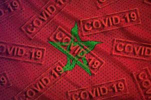 Morocco flag and many red Covid-19 stamps. Coronavirus or 2019-nCov virus concept photo