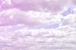 A blue sky with lots of white clouds of different sizes photo