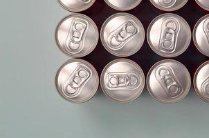 Many new aluminium cans of soda soft drink or energy drink containers. Drinks manufacturing concept and mass production photo