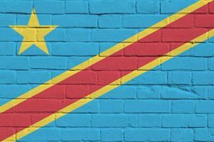 Democratic Republic of the Congo flag depicted in paint colors on old brick wall. Textured banner on big brick wall masonry background photo