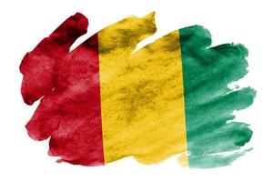 Guinea flag is depicted in liquid watercolor style isolated on white background photo