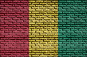 Guinea flag is painted onto an old brick wall photo