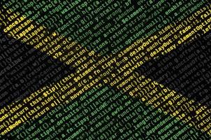 Jamaica flag is depicted on the screen with the program code. The concept of modern technology and site development photo