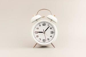 White clock on gray background, time concept that matters to life and work. photo