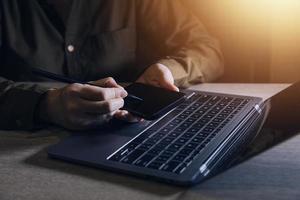 businesswoman hand working with laptop computer, tablet and smart phone in modern office with virtual icon diagram at modernoffice in morning light photo