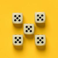 Ideally placed dice, their number and value are the same, on a yellow background. Top view. photo