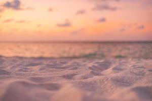 Relaxing sea sand sky and summer day. Sunset beach background. Vacation concept closeup sandy dunes, blurred sunset sea view and horizon. Mediterranean sunrise beach shore, idyllic tourism landscape photo