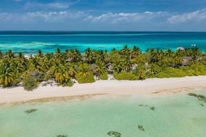 Luxury villas with coconut palm trees, blue lagoon, white sandy beach at Maldives islands. Beautiful summer vacation, holiday landscape. Amazing relaxing nature aerial scene, traveling background photo