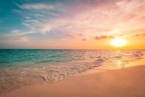 Closeup sea sand beach. Panoramic beach landscape. Inspire tropical seascape horizon. Orange and golden sunset sky clouds. Tranquil relaxing freedom beach shore happy romantic meditation summer nature photo